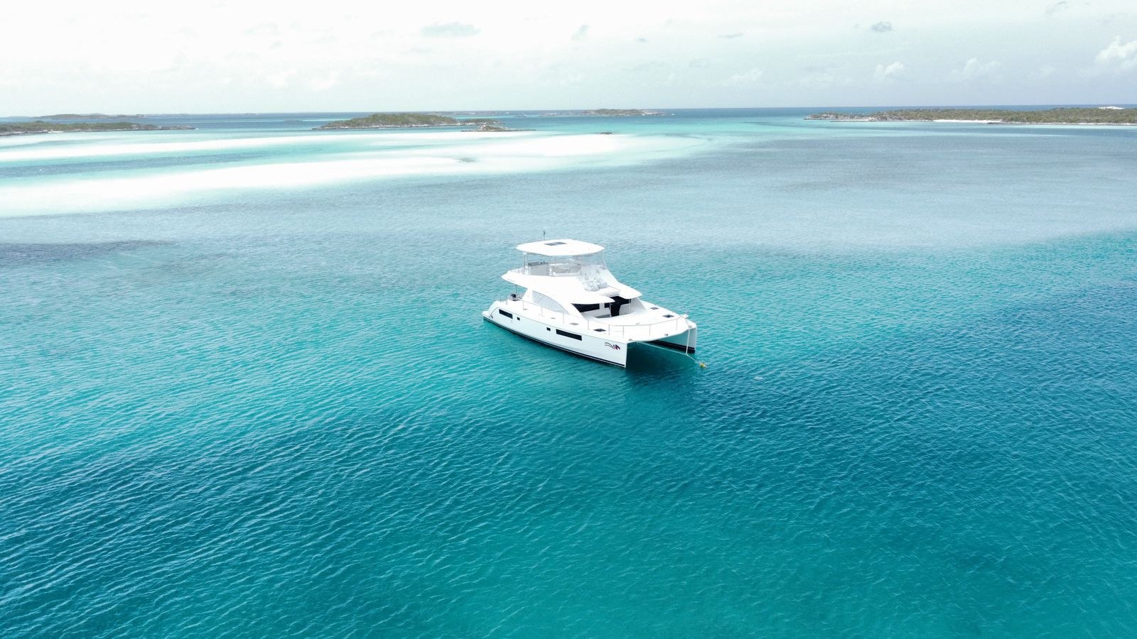 Stock photograph of a white yacht on turquoise water